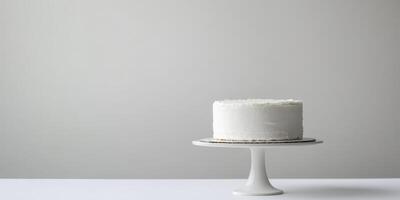 This exquisite and elegant white birthday cake is artistically displayed on a contemporary stand against a subtle and soft background, making it an ideal choice for any kind of celebration or event photo