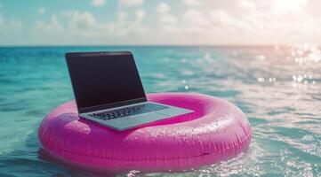 A sleek laptop sits on a pink pool float in calm waters, showcasing the blend of work and leisurea perfect retreat for workaholics needing a break to relax and recharge from hectic schedules photo