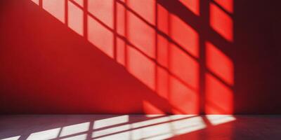A vibrant red wall is casting intricate shadows, creating beautiful light patterns throughout the space photo