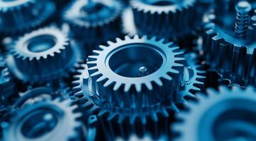 A closeup view of intricately interlocked blue metal gears, which symbolize the essential elements of teamwork, precision, and careful mechanical engineering in advanced machinery and automation photo