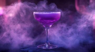 A truly stunning purple cocktail is surrounded by a mesmerizing and enchanting fog, which is artfully created using liquid nitrogen, ensuring a captivating and unforgettable presentation for all photo