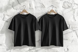 This mockup illustrates a plain black tshirt, featuring both the front and back views, showcased against an elegant white wall, making it perfect for clothing design presentations and ideas photo