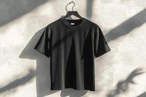 A sleek and stylish black tshirt is elegantly displayed against a modern backdrop with soft, gentle shadows photo