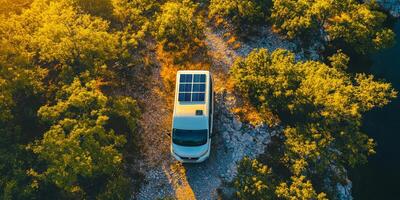 A charming campervan is parked in a serene and peaceful setting, equipped with a solar panel to provide sustainable electricity, which promotes ecofriendly travel while inspiring exciting adventures photo