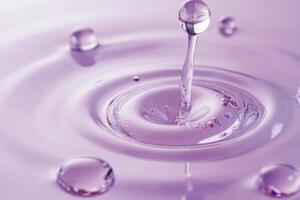 A beautifully serene image showcasing water droplets delicately creating mesmerizing ripples in a soft purple setting photo