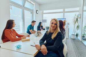 Diverse Business Team Discussing Projects in a Modern Glass Office. photo