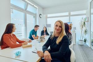 Diverse Business Team Discussing Projects in a Modern Glass Office. photo