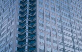 Skyscraper glass building of corporate headquarters in the downtown business area. Towering facade and windows embodying sleek, modern office environment. Financial institution. Modern architecture. photo