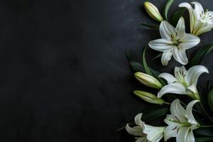 Condolences card with white lilies on black background, copy space photo