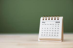 Calendar page May of the year 2025 white color on green background. with copy space and business design. concept of planning and setting new strategic goals. photo