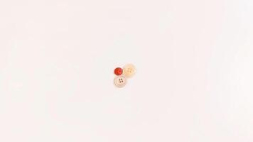 Buttons of various colors and shapes scattered on a white background. photo