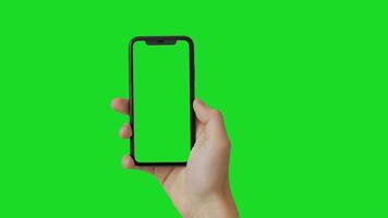Modern smart phone in hand close-up. Isolated screen and background in green. photo
