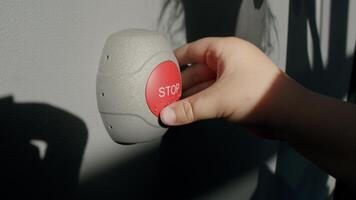 Stop Button and the Hand of Worker About to Press it. emergency stop button. Big Red emergency button or stop button for manual pressing. photo