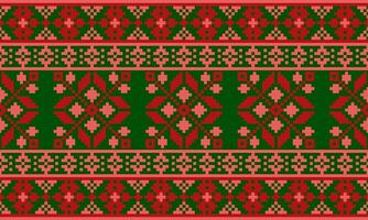 a detailed pattern composed of pixel designs with red and pink square on green background , design for fabric or various pattern printing works. vector