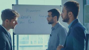 Business people diverse colleagues discussing marketing strategy presentation pitch sales manager CEO networking HR talent management graph data statistics on a whiteboard development video
