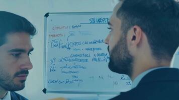 Business people diverse colleagues discussing marketing strategy presentation pitch sales manager CEO networking HR talent management graph data statistics on a whiteboard development video