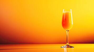 Bright and refreshing orange juice in a tall glass against a vibrant orange background, perfect for breakfast or brunch. photo