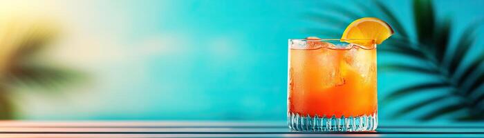 A refreshing cocktail with ice and orange slice, perfect for summer vibes and beach settings under a vibrant blue sky. photo