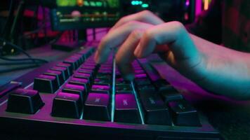 Close up hands man typing keyboard computer pc play game programmer neon cyberspace hacking network competition electronic fingers technology connection social media internet coding chatting texting video