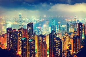 Scenic view over Hong-Kong, China, by night. Nighttime skyline with illuminated skyscrapers seen from Victoria Peak. photo