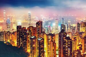 Scenic view over Hong-Kong, China, by night. Nighttime skyline with illuminated skyscrapers seen from Victoria Peak. photo