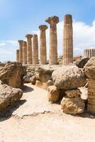 Agrigento, Italy-May 10, 2022-view of the columns oh the Temple of Hercules inside the valley of the temples, an archaeological park near Agrigento during a sunny day photo
