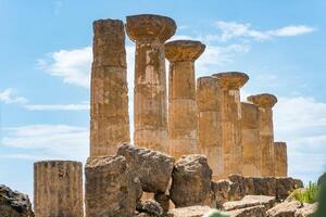 Agrigento, Italy-May 10, 2022-view of the columns oh the Temple of Hercules inside the valley of the temples, an archaeological park near Agrigento during a sunny day photo