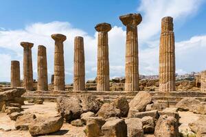 Agrigento, Italy-May 10, 2022-view of the columns oh the Temple of Hercules inside the valley of the temples, an archaeological park near Agrigento during a sunny day photo