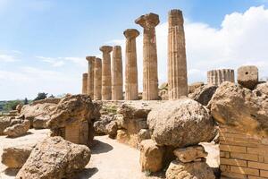 Agrigento, Italy-May 10, 2022-view of the columns oh the Temple of Hercules inside the valley of the temples, an archaeological park near Agrigento during a sunny day photo