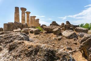 Agrigento, Italy-May 10, 2022-view of the columns oh the Temple of Hercules inside the valley of the temples, an archaeological park near Agrigento during a sunny day photo