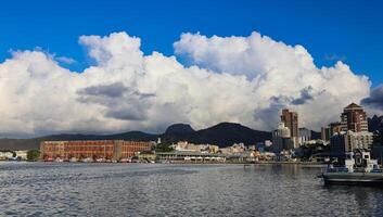 A photograph capturing the view of Port Louis City in Mauritius, showcasing its remarkable skyline filled with numerous towering buildings. photo