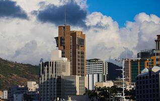 A photograph capturing the view of Port Louis City in Mauritius, showcasing its remarkable skyline filled with numerous towering buildings. photo