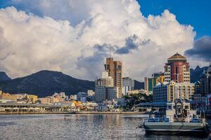 A photograph capturing the view of Port Louis City in Mauritius, showcasing its remarkable skyline filled with numerous towering buildings. photo