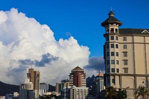 A photograph capturing the view of Port Louis City in Mauritius, showcasing its remarkable skyline filled with numerous towering buildings. photo
