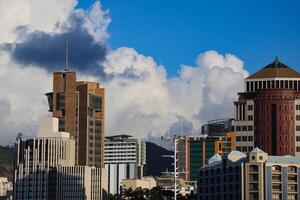 A photograph capturing the view of Port Louis City in Mauritius, showcasing its remarkable skyline filled with numerous towering buildings. photo