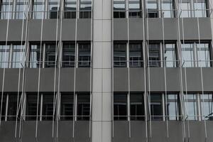 large building with many windows and a metal railing photo