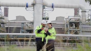 Two engineer working Industry in oil refinery equipment Check and check the condition of the machinery system , Engineering concept. video