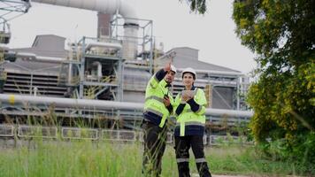 Two engineer working Industry in oil refinery equipment Check and check the condition of the machinery system , Engineering concept. video