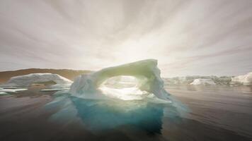 A large iceberg floating on top of a body of water video