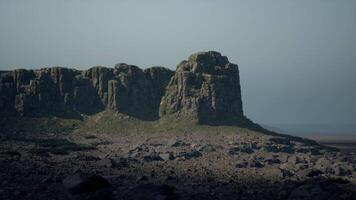 A large rock outcropping in the middle of a field video