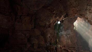 A light shines through a hole in a mountain video