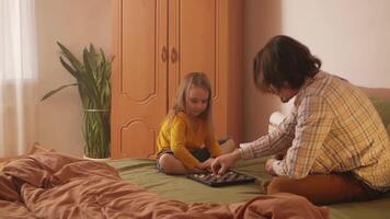 Joyful dad and little girl have fun with checkers. video