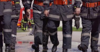 A specialized firefighting unit equipped with special attire and advanced equipment embarks on a hazardous fire suppression mission, showcasing their professionalism and readiness to combat fires in video