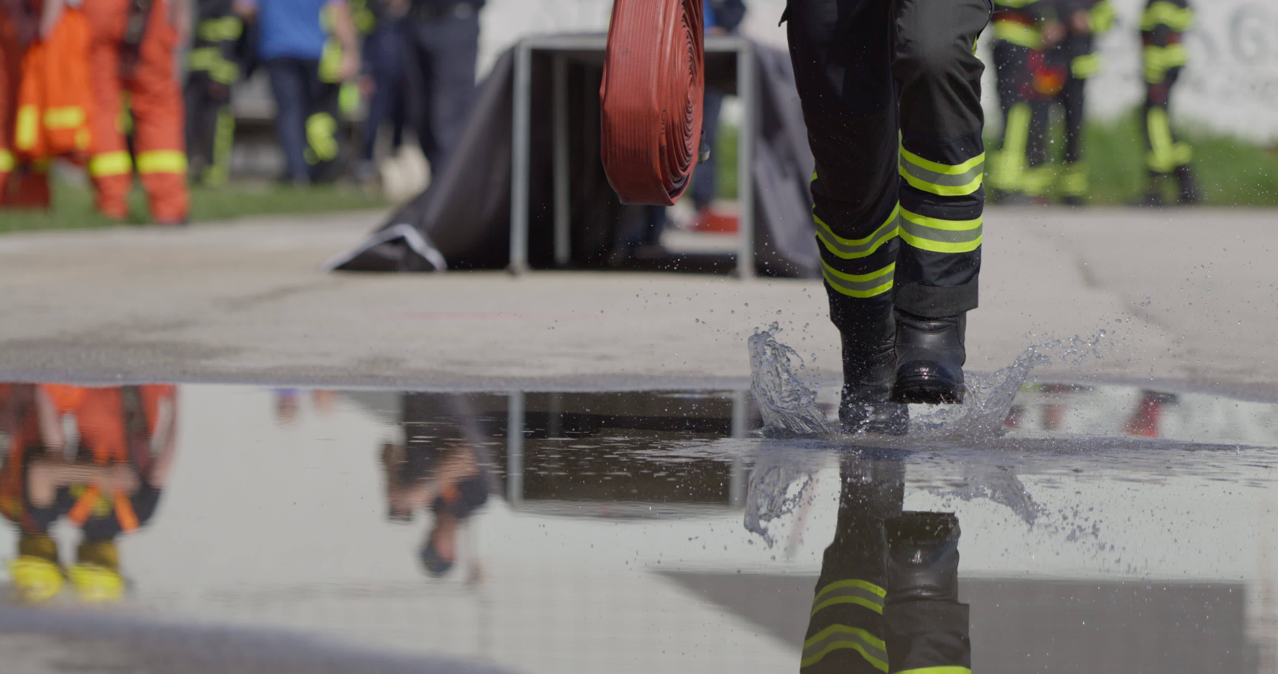 A team of firefighters swiftly readies water hoses, demonstrating their