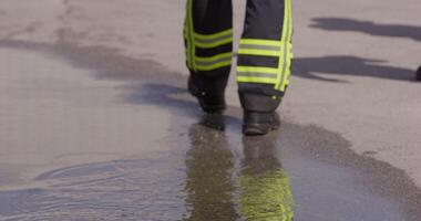 The reflection in water reveals a team of specially equipped firefighters coordinating and embarking on a high-risk, life-saving mission to rescue people in distress, showcasing their unwavering video