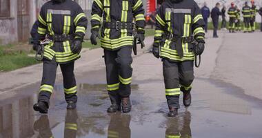 The reflection in water reveals a team of specially equipped firefighters coordinating and embarking on a high-risk, life-saving mission to rescue people in distress, showcasing their unwavering video