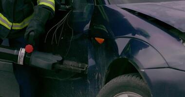 A skilled team of firefighters employs specialized tools and quick reactions to successfully extricate a person trapped in a car, showcasing their heroism and precision in a high-stakes rescue video