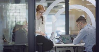 A diverse group of colleagues collaboratively and efficiently tackles various business tasks in a modern office, exemplifying teamwork, productivity, and a dynamic corporate environment. video