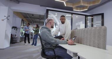 A diverse group of colleagues collaboratively and efficiently tackles various business tasks in a modern office, exemplifying teamwork, productivity, and a dynamic corporate environment. video