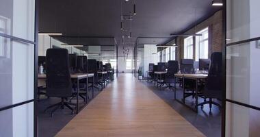 Modern startup centers composed of glass offices within a contemporary corporate environment, highlighting the sleek, innovative, and minimalist design aesthetics of a cutting-edge workspace video